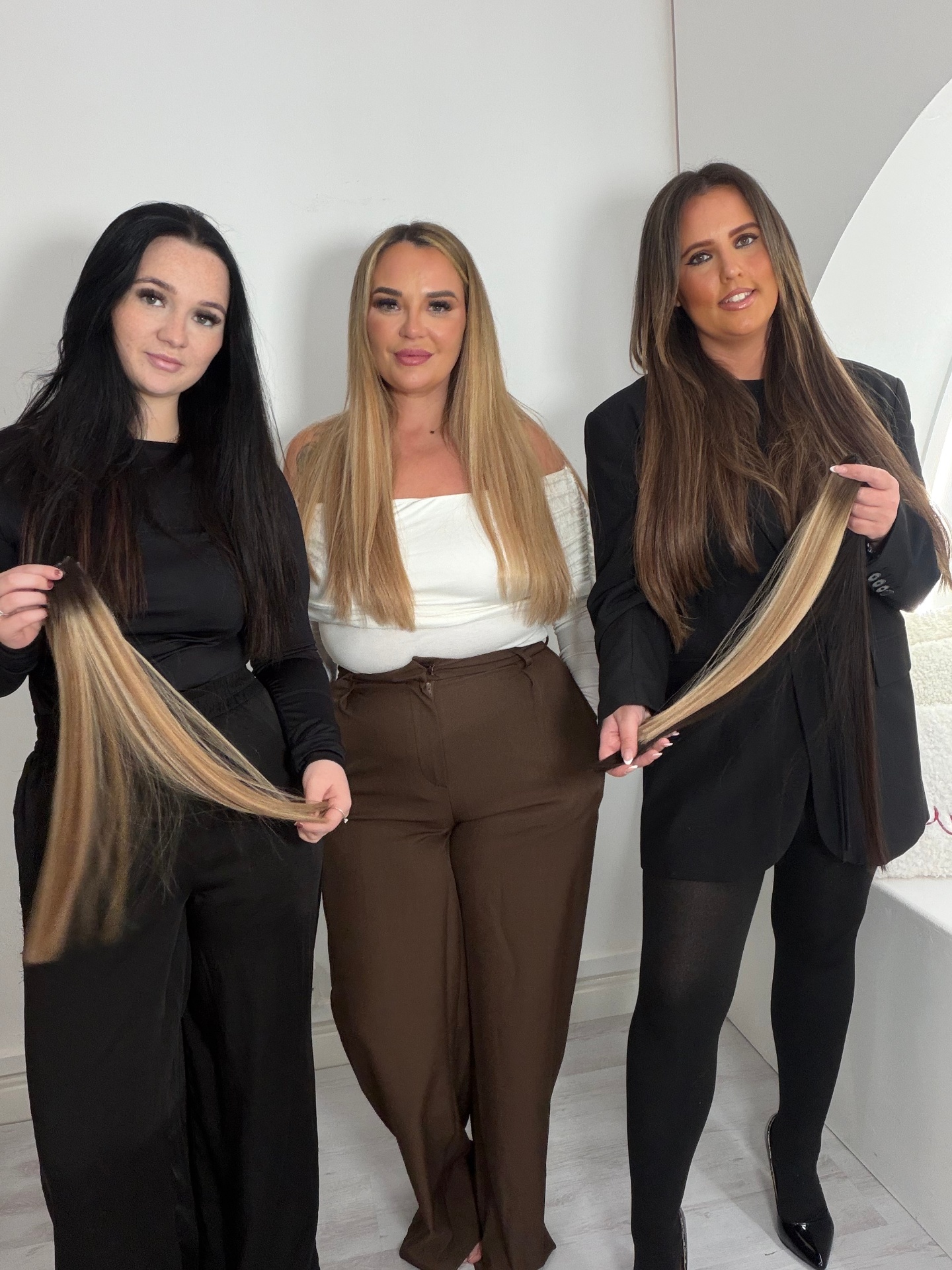 Blondie Locks stylists showing their hair extension work
